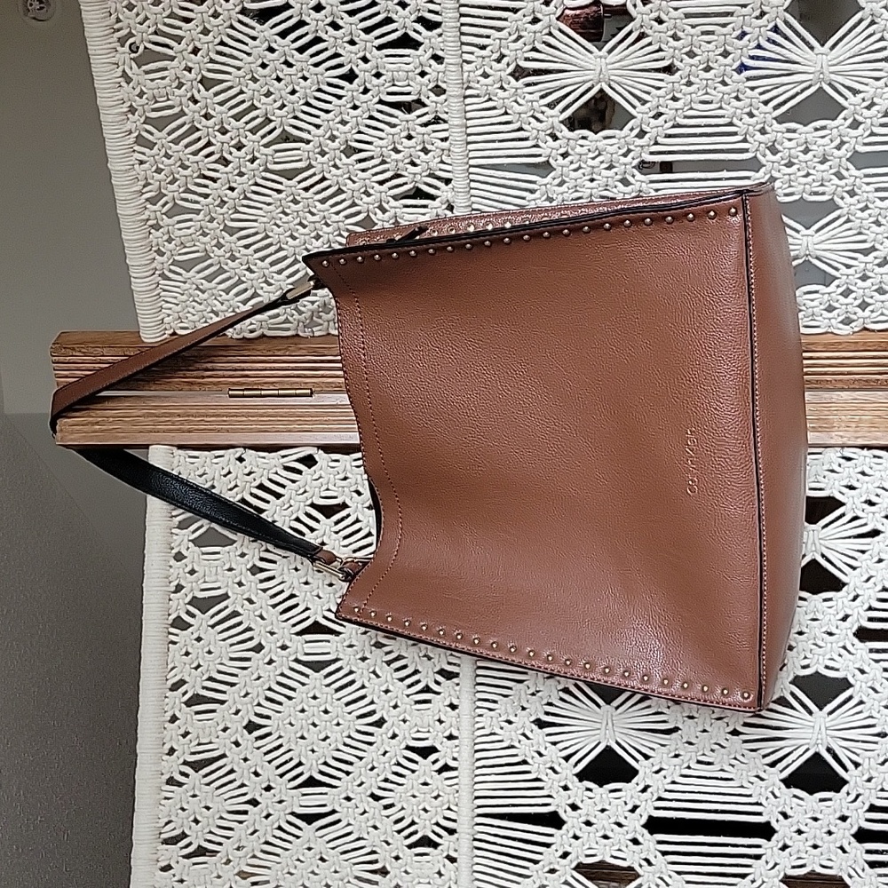Calvin Klein tote bag. Brown with gold studs front/back. 11" deep 12" wide.